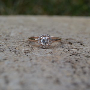 Custom designed round diamond halo engagement ring in rose gold