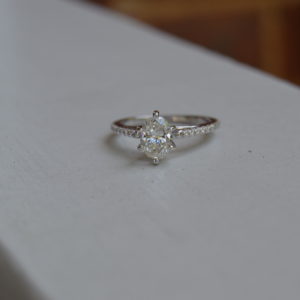 Custom designed oval diamond (6 prongs) engagement ring with shared prong set diamonds in the shank