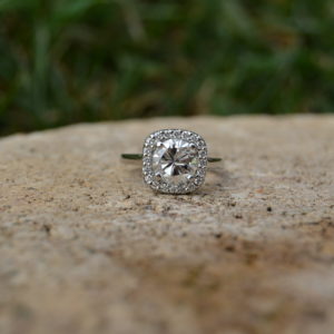 Custom designed round diamond with cushion shaped diamond halo engagement ring