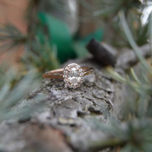 Custom designed oval diamond halo engagement ring in rose gold