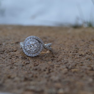 Custom designed round diamond engagement ring with twist halo