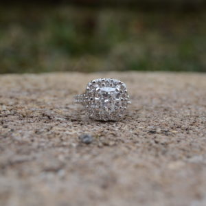 Custom designed cushion shaped diamond engagement ring with cushion shaped diamond halo and shared prong set ideal cut diamonds in shank