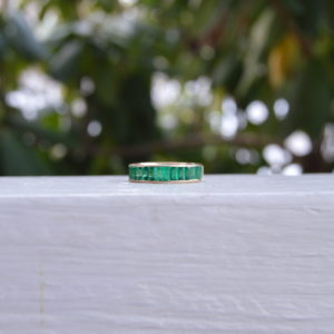 Custom Designed Emerald Shaped Emerald Channel Set Band in Yellow Gold
