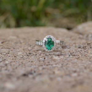 Custom Designed White Gold Oval Emerald and Diamond Halo Ring with Channel Set Diamonds in Shank