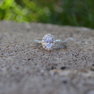 Custom Designed Oval Diamond Halo Engagement Ring in White Gold with Shared Prong Set Diamond Shank