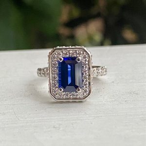 Custom Designed Emerald Cut Sapphire and Diamond Halo Ring with Diamond Shank
