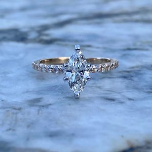 Custom Designed Marquise Diamond Solitaire with Round Diamonds in Shared Prong Shank
